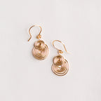 aretes espiral dorados y sobre fondo blanco